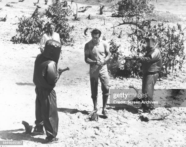 Sean Connery and Ursula Andress are taken prisoner on Caribbean Island in a scene from the 1962 James Bond film 'Dr No'.