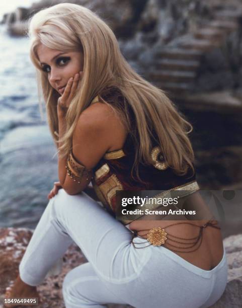 Pamela Tiffin poses in white pants and top with bare midriff circa 1966.