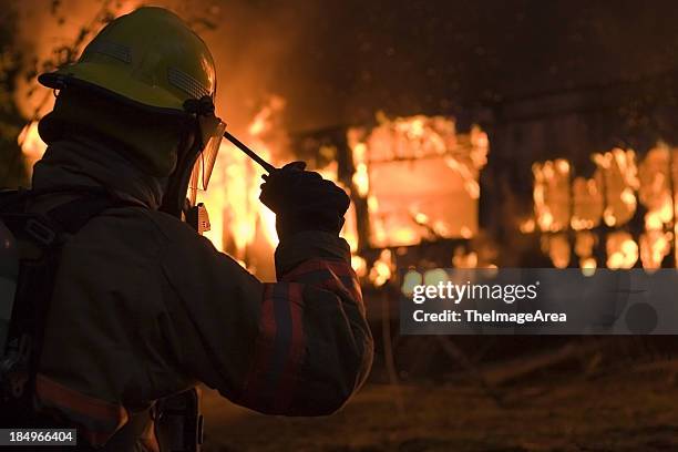 fireman on radio 2 - emergancy communication stock pictures, royalty-free photos & images