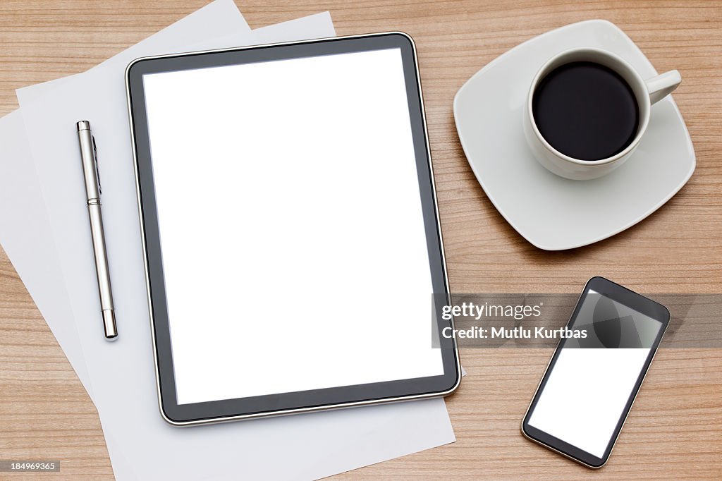 Coffee mug with tablet computer and smartphone