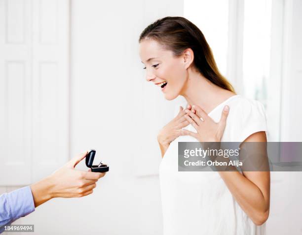 woman receiving an engagement gift - man holding ring box stock pictures, royalty-free photos & images