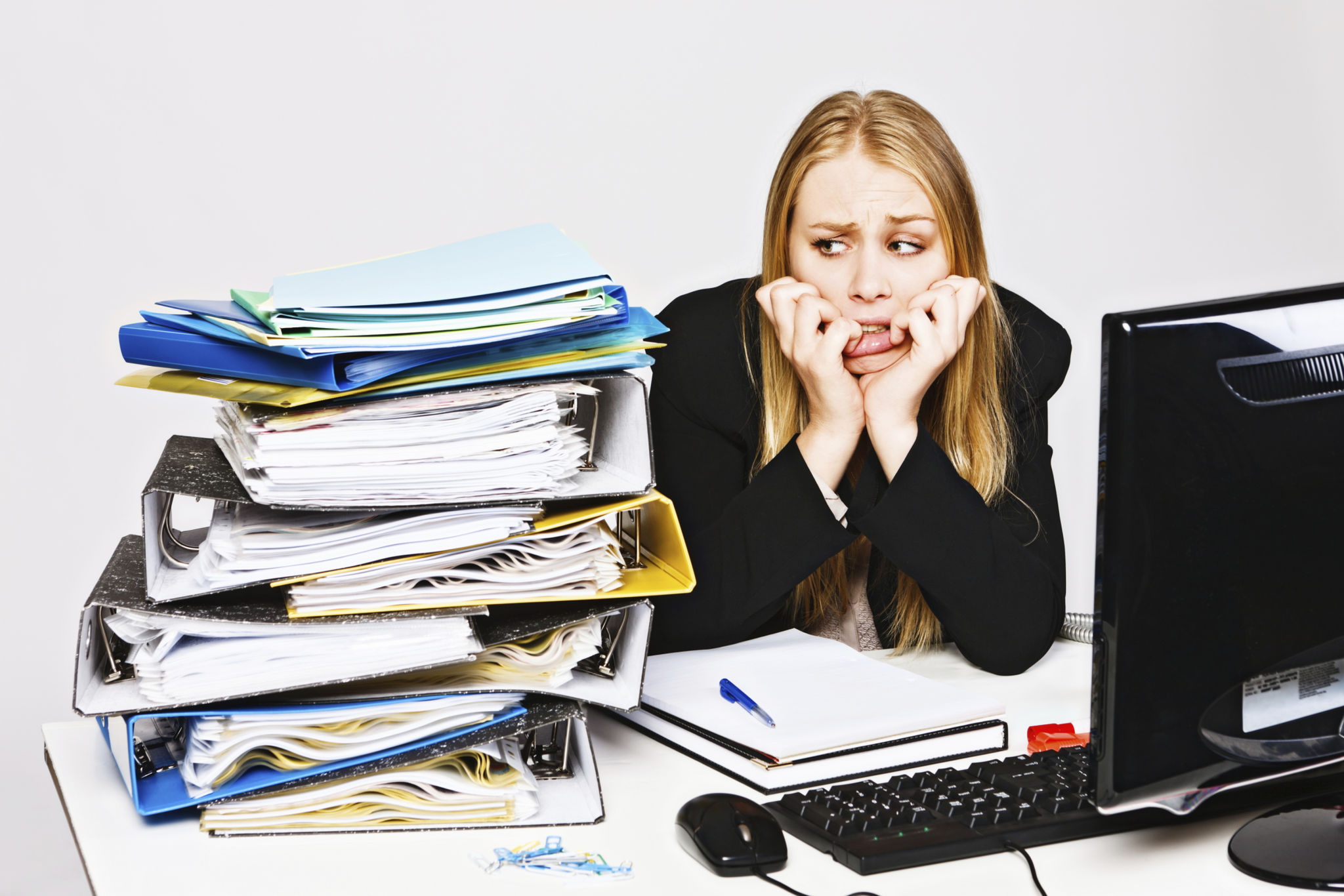 Glum depressed businesswoman biting her nails eyes workload nervously Glum depressed businesswoman biting her nails eyes workload nervously