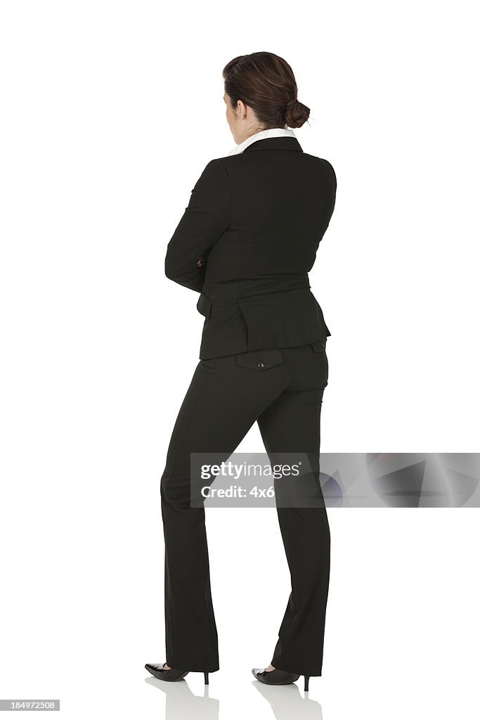 Rear view of a businesswoman standing with arms crossed