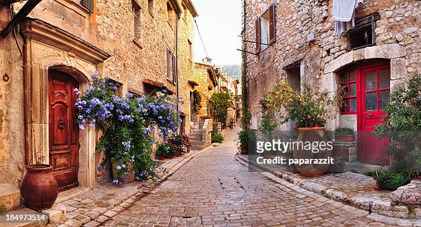 old french village houses and cobblestone street - village stock pictures, royalty-free photos & images