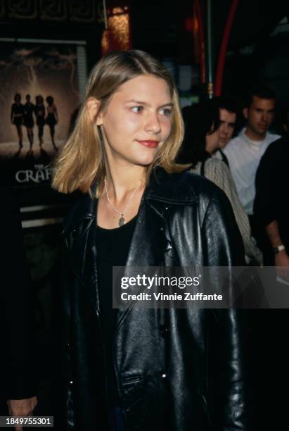 American actress Claire Danes, wearing a black leather jacket over a black scoop neck top, attends the Hollywood premiere of 'The Craft', held at...