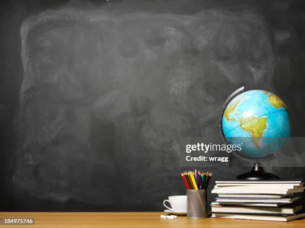 world globe on books on school teacher's desk - bordsjordglob bildbanksfoton och bilder