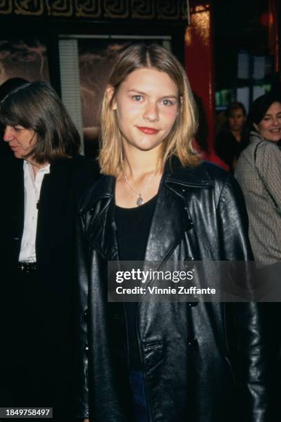 American actress Claire Danes, wearing a black leather jacket over a black scoop neck top, attends the Hollywood premiere of 'The Craft', held at...