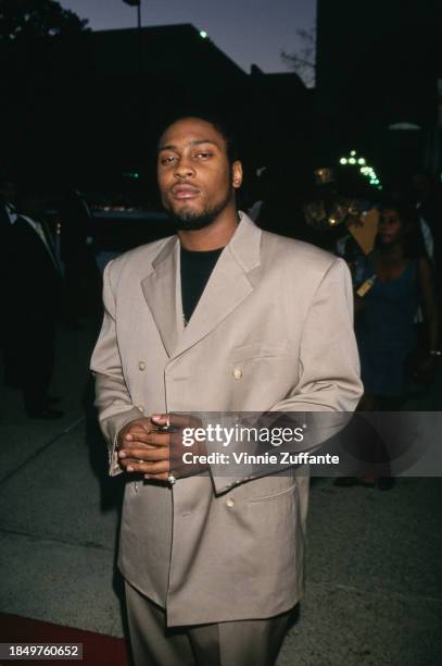 American singer and songwriter D'Angelo, wearing a beige double-breasted suit over a black crew-neck t-shirt, attends the 1996 NAACP Image Awards,...