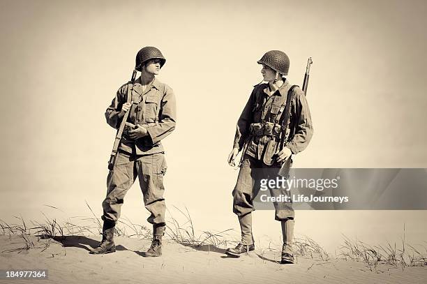 two vintage wwii soldiers - world war ii stock pictures, royalty-free photos & images