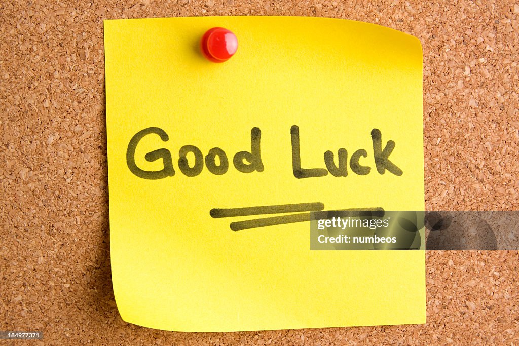 A post it note saying Good Luck with a red pin