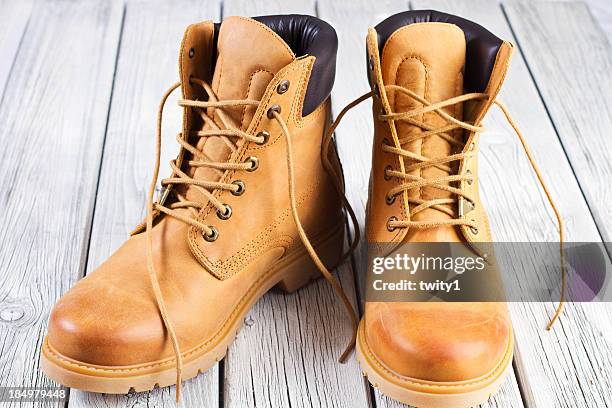 yellow boots - arbeitsstiefel stock-fotos und bilder