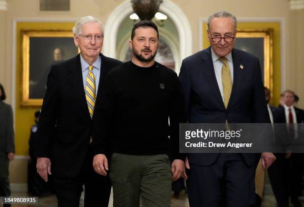 Ukrainian President Volodymyr Zelensky walks with Senate Minority Leader Mitch McConnell and Senate Majority Leader Charles Schumer as he arrives at...