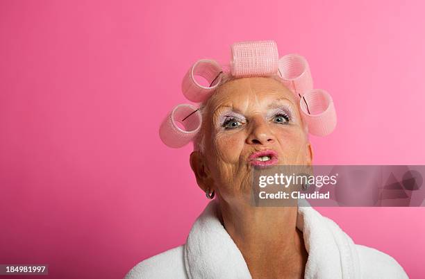 senior woman with curlers - old ugly woman stockfoto's en -beelden