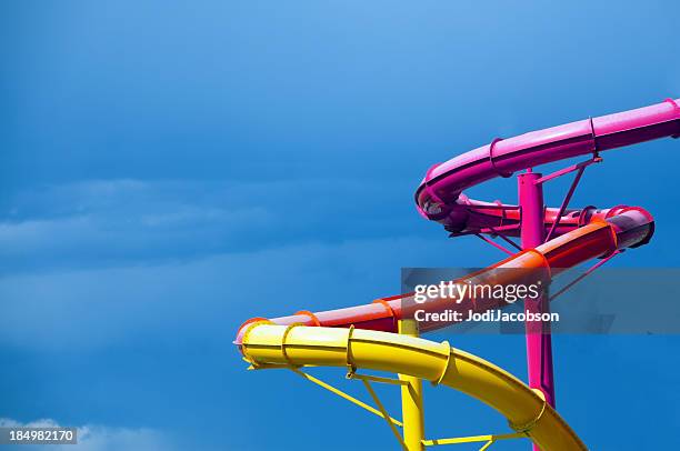 bright colored water slides - water slide stockfoto's en -beelden