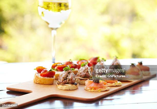 bruschetta with cheese, tomatoes, foie gras, and wild salmon - appetizer stockfoto's en -beelden