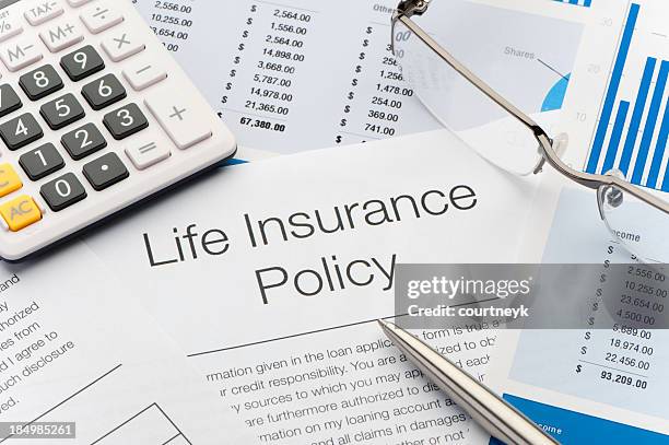 close up of life insurance policy - levensverzekering stockfoto's en -beelden