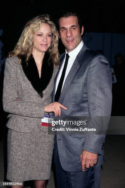 American actress Ally Walker, wearing a grey suit with a black fur collar, and American actor and singer Robert Davi, who wears a grey suit over a...