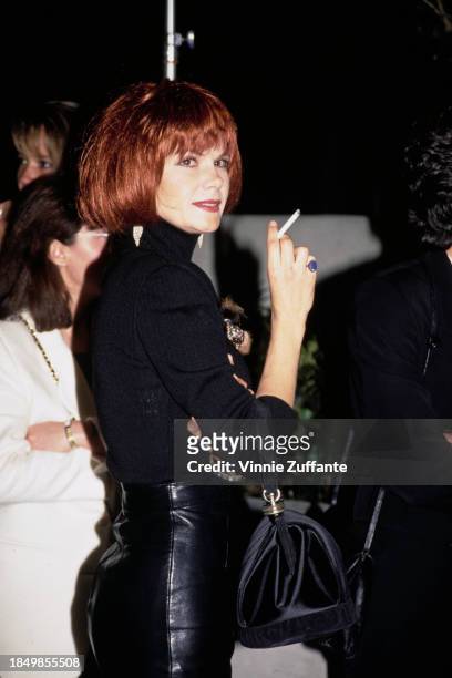 Canadian actress Lolita Davidovich, wearing a black turtleneck sweater, attends the Westwood premiere of 'White Men Can't Jump', held at Avco Center...