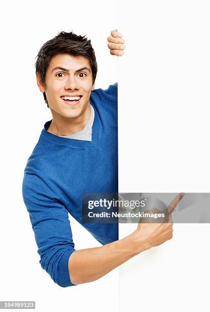 man pointing at a blank wall - isolated - gluren stockfoto's en -beelden