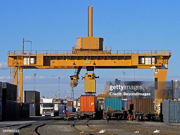 loading freight containers at city intermodal hub - rail freight stock pictures, royalty-free photos & images