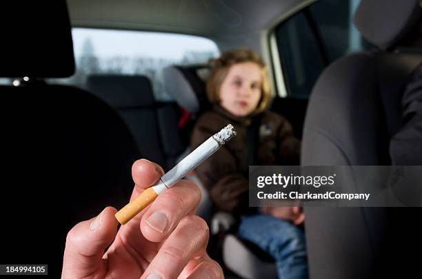 young children suffering the effects of in car passive smoking - inside car stockfoto's en -beelden