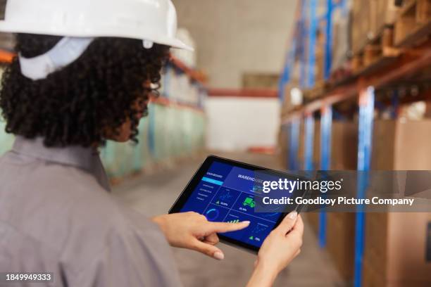 female engineer using a tablet app to track shipments in a warehouse - tablet screen stock pictures, royalty-free photos & images