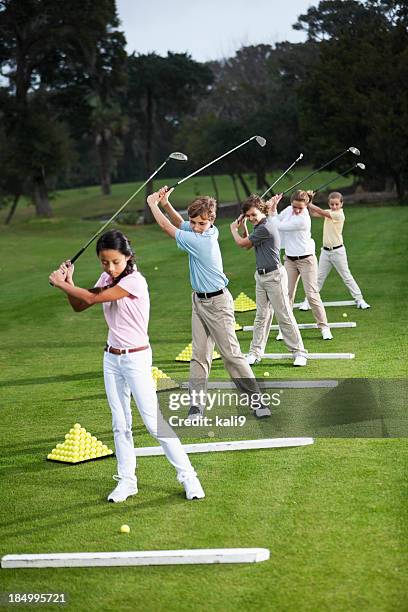 group of children on golf driving range - driving-range stock pictures, royalty-free photos & images