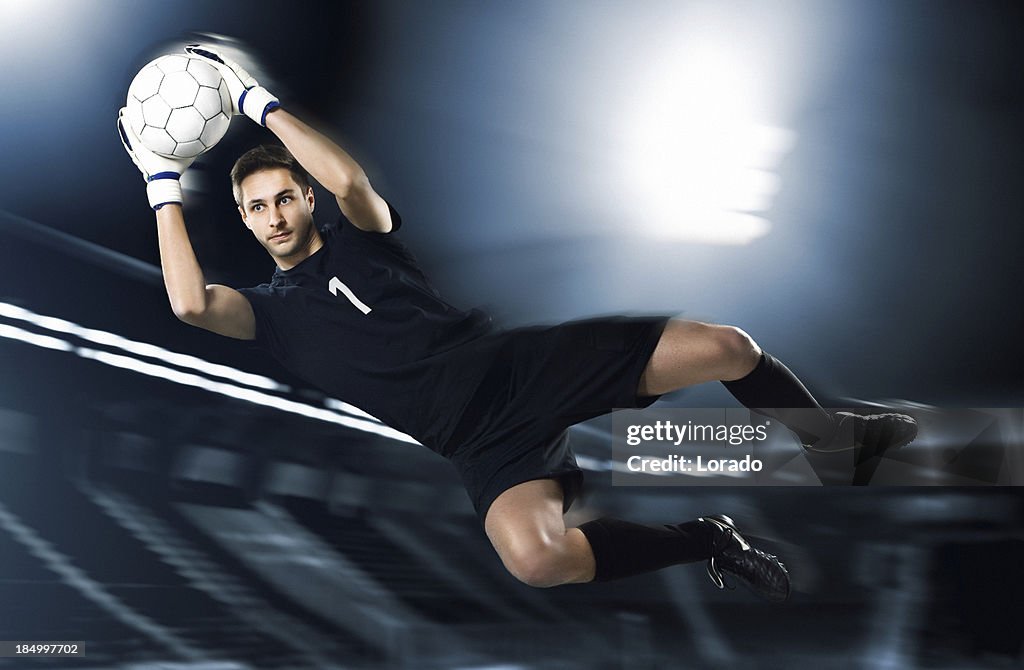 Soccer goalkeeper catching ball in mid-air