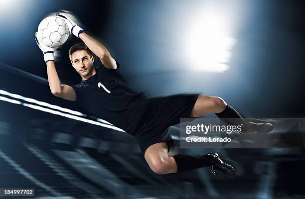 soccer goalkeeper catching ball in mid-air - man catching stock pictures, royalty-free photos & images