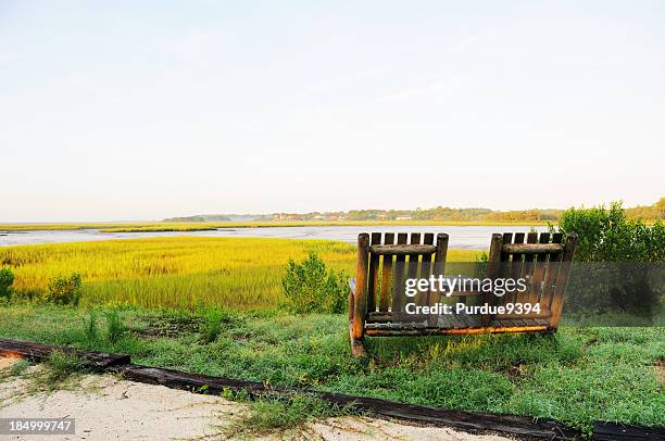 two chairs overlooking amelia island florida river marsh at dawn - amelia island stock pictures, royalty-free photos & images