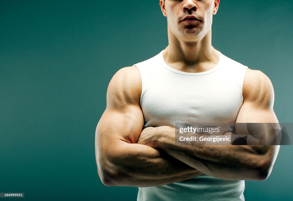 Strong guy with crossed arms