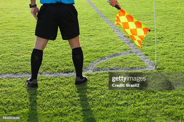 a soccer referee playing close attention on the aisle - referee stripes stock pictures, royalty-free photos & images