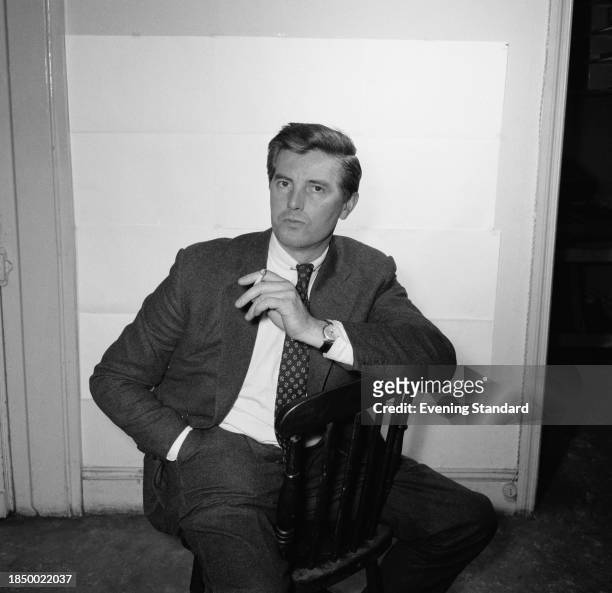 Author and Evening Standard staff journalist Kenneth Allsop posing on a chair, May 17th 1956.