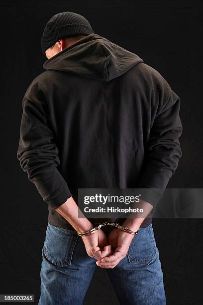 robber on black handcuffed - hands behind back stock pictures, royalty-free photos & images