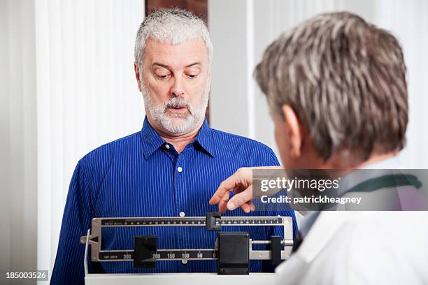 doctor weighing patient - doctor's office scale stock pictures, royalty-free photos & images