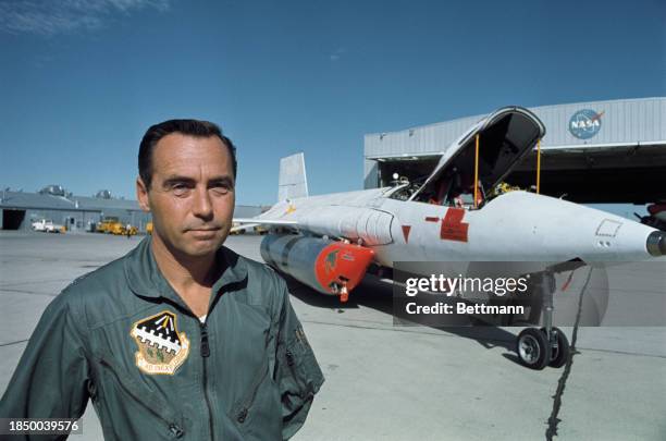 Aeronautical engineer and test pilot William 'Pete' Knight standing near the X-15 rocket plane at Edwards Air Force Base in California, September...