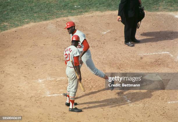 Bob Gibson of the St Louis Cardinals is congratulated by Lou Brock after hitting a home run in the final game of the World Series against the Boston...