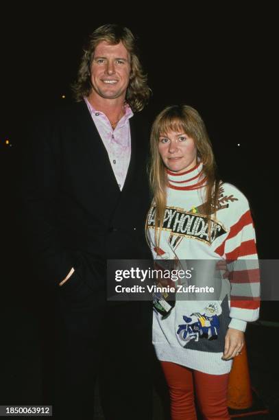 Canadian wrestler 'Rowdy' Roddy Piper attending an event with a woman friend, circa 1995.