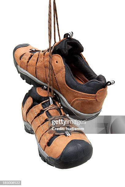 hiking boots hanging isolated on white background - hiking boot stock pictures, royalty-free photos & images