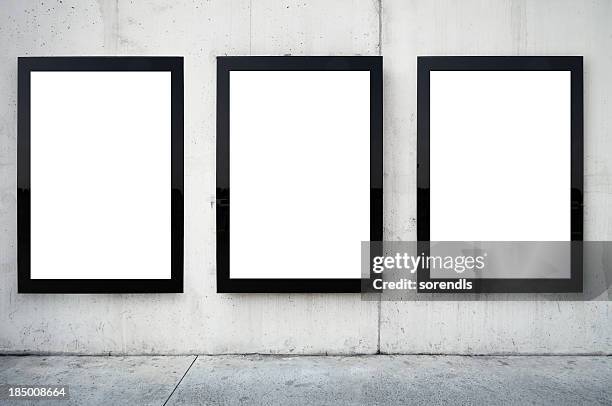 three blank billboards on wall. - reclamebord activiteit stockfoto's en -beelden