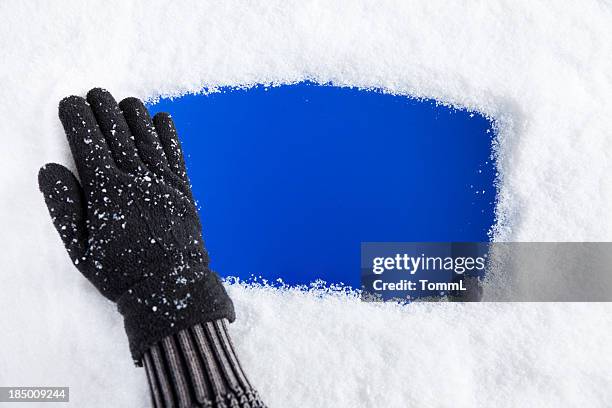 hand removing snow from window - glove removal stock pictures, royalty-free photos & images