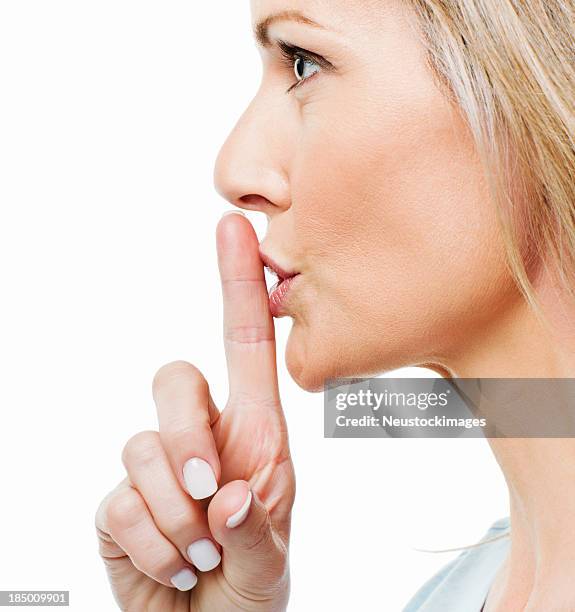 woman asking for silence - finger on lips stock pictures, royalty-free photos & images
