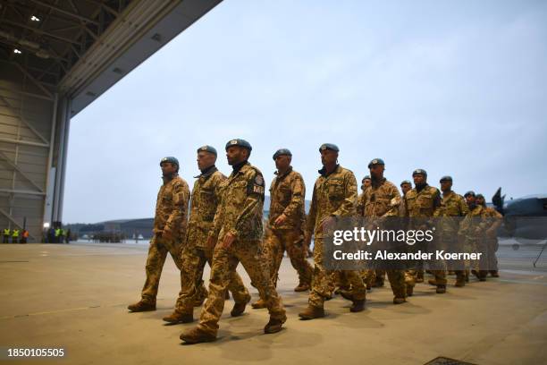 Soldiers of the Bundeswehr stand in line after leaving an A400m transport plane as they return from Mali on December 15, 2023 in Wunstorf, Germany....