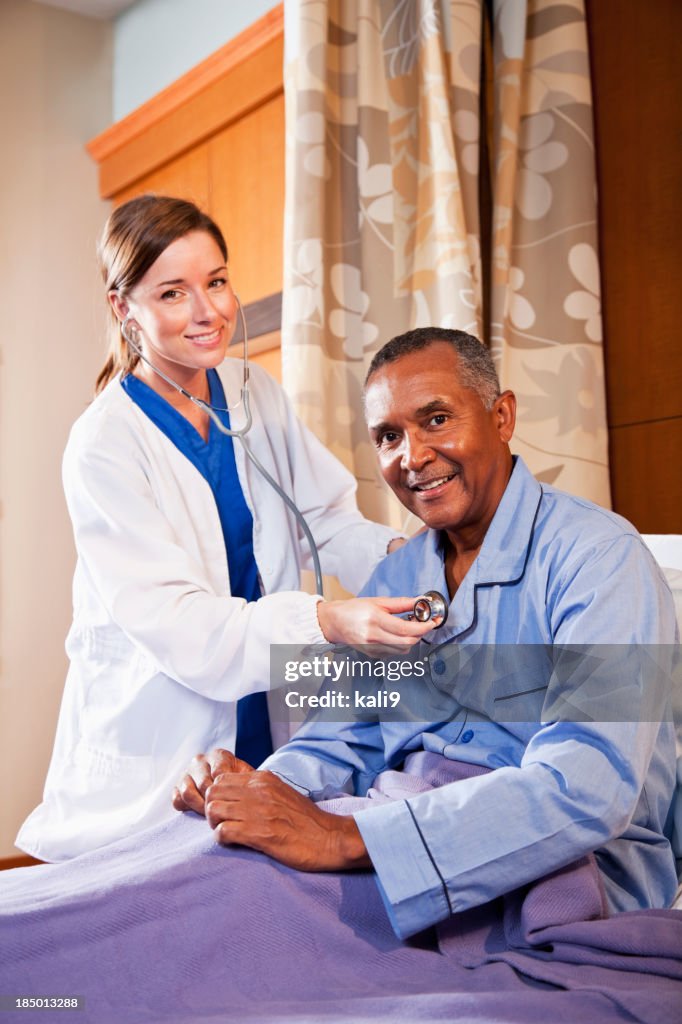 Doctor using stethoscope on senior patient