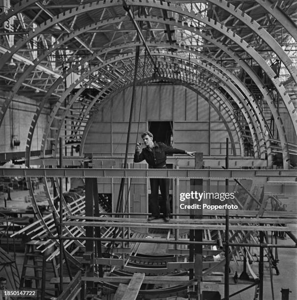 An employee at work constructing the airframe of a mock-up fuselage of the prototype Bristol Brabazon propeller-driven airliner in a hanger at the...