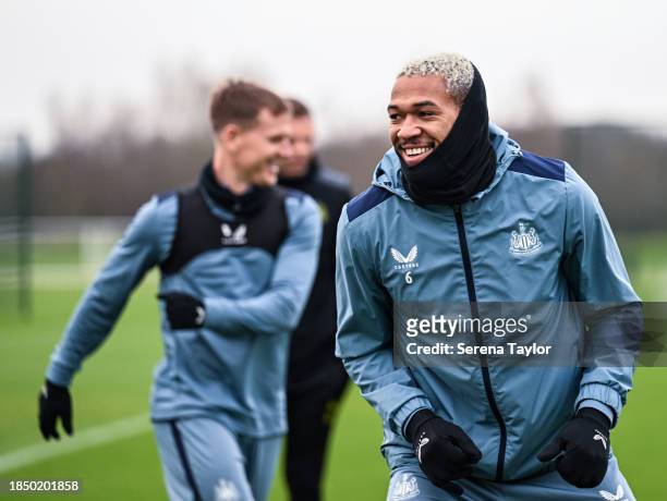 Joelinton smiles as he warms up during the Newcastle United Training Session at the Newcastle United Training Centre on December 12, 2023 in...
