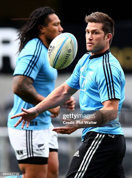 Cory Jane of the All Blacks passes during a New Zealand All Blacks training session at the Forsyth Barr Stadium on October 17, 2013 in Dunedin, New...