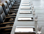 The boardroom table is set for a meeting