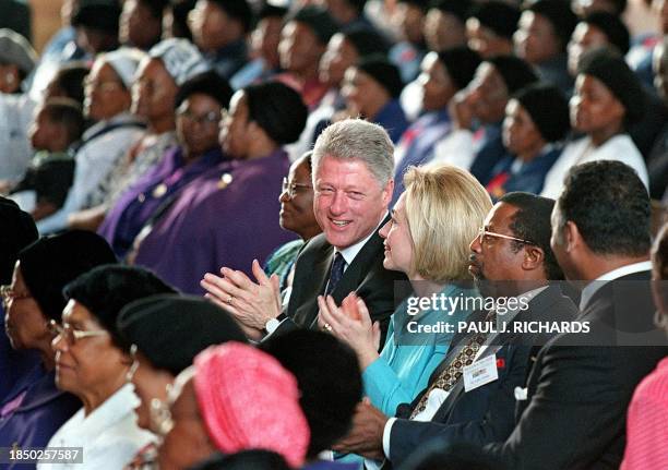 President Bill Clinton and his wife Hillary clap their hands, 29 March during sunday mass. The Baptist President attended the church service at the...