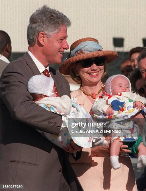 American President Bill Clinton and his wife Hillary cuddle 28 March babies of American citizens living in Cape Town who gathered at Cape Town...